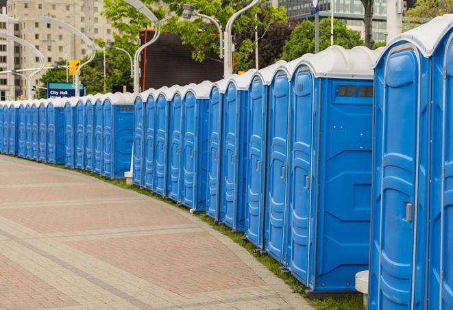 a row of portable restrooms set up for a large athletic event, allowing participants and spectators to easily take care of their needs in East Boston MA